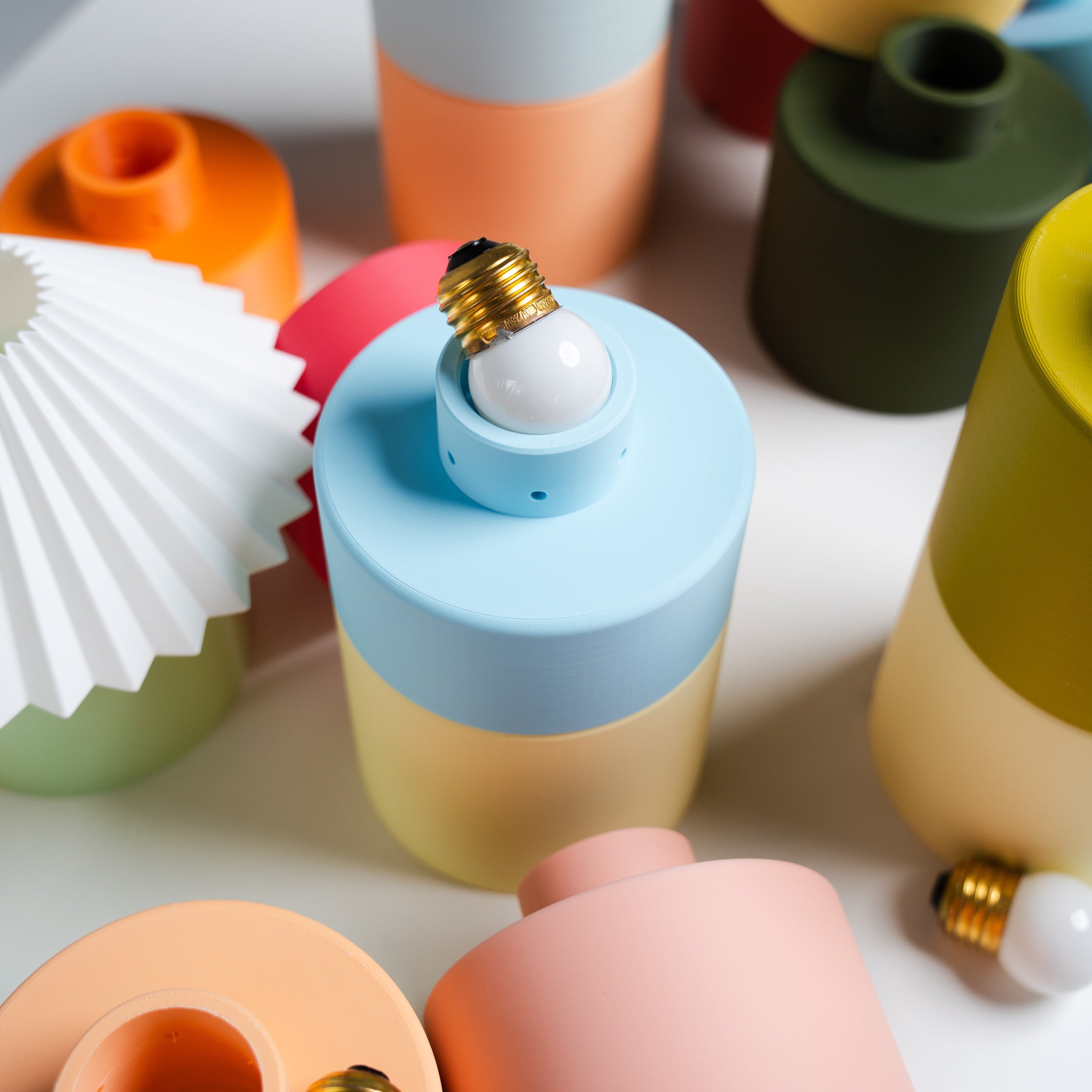 colorful lamp bases designed to stack and play by nella home